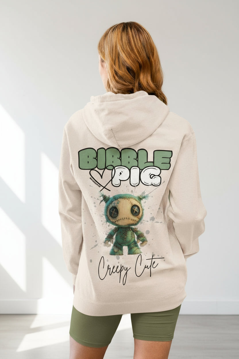 Model wearing a cream organic hoodie featuring goth style creepy cute Night Terror Voodoo style graphic.