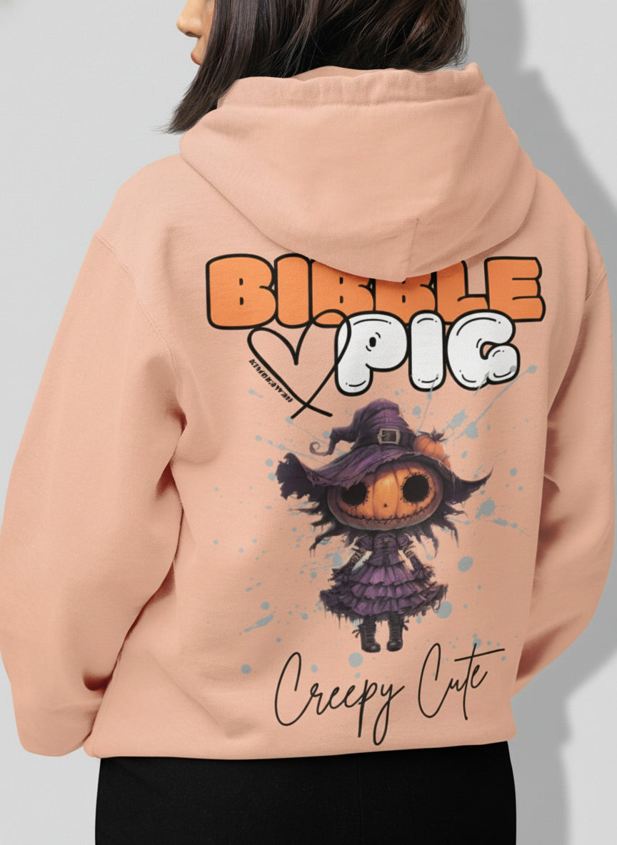 Close up view of a Model wearing a peach organic hoodie featuring goth style creepy cute Pumpkin Willow graphic. 