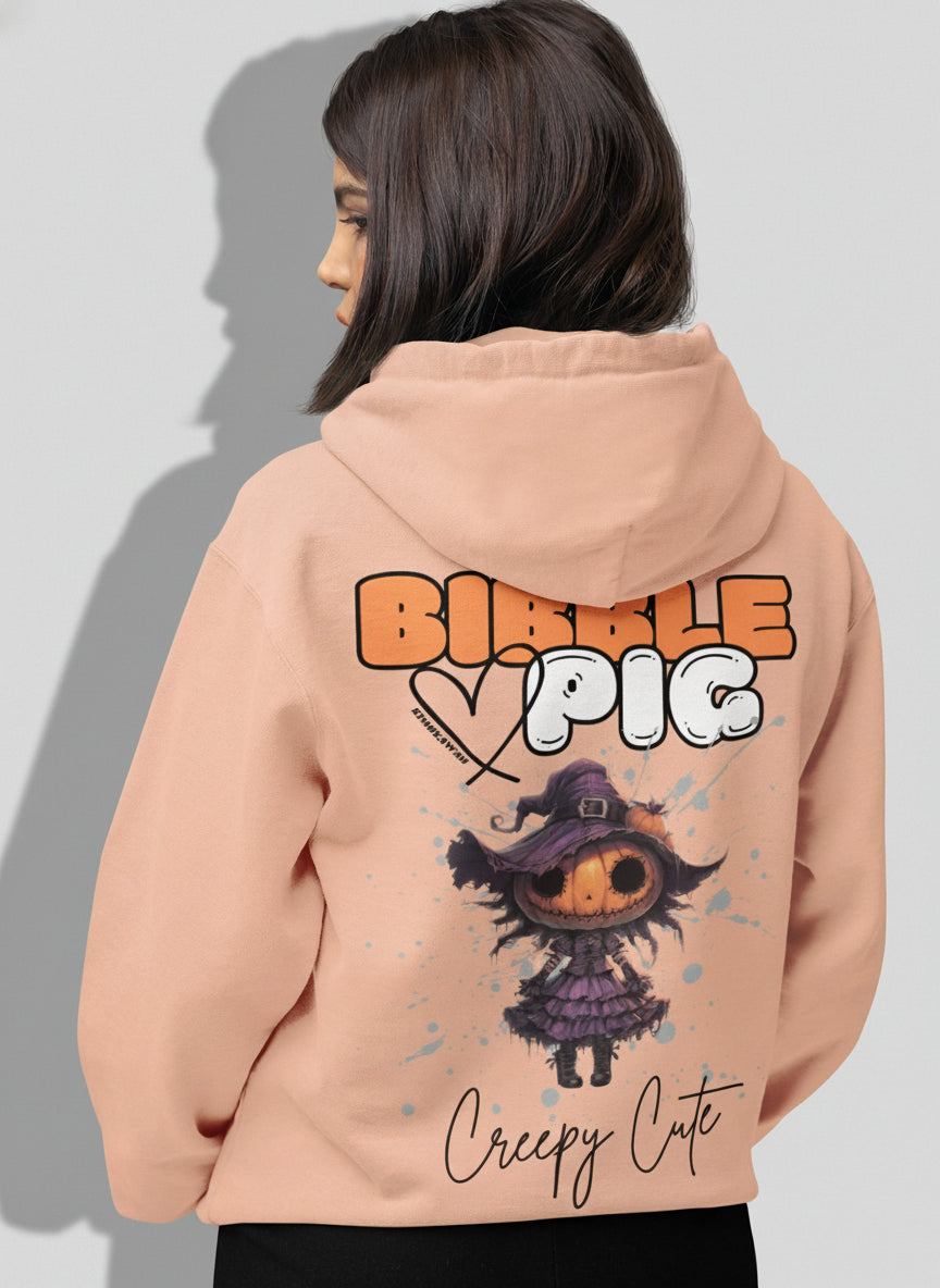 Model wearing a peach organic hoodie featuring goth style creepy cute Pumpkin Willow graphic. 