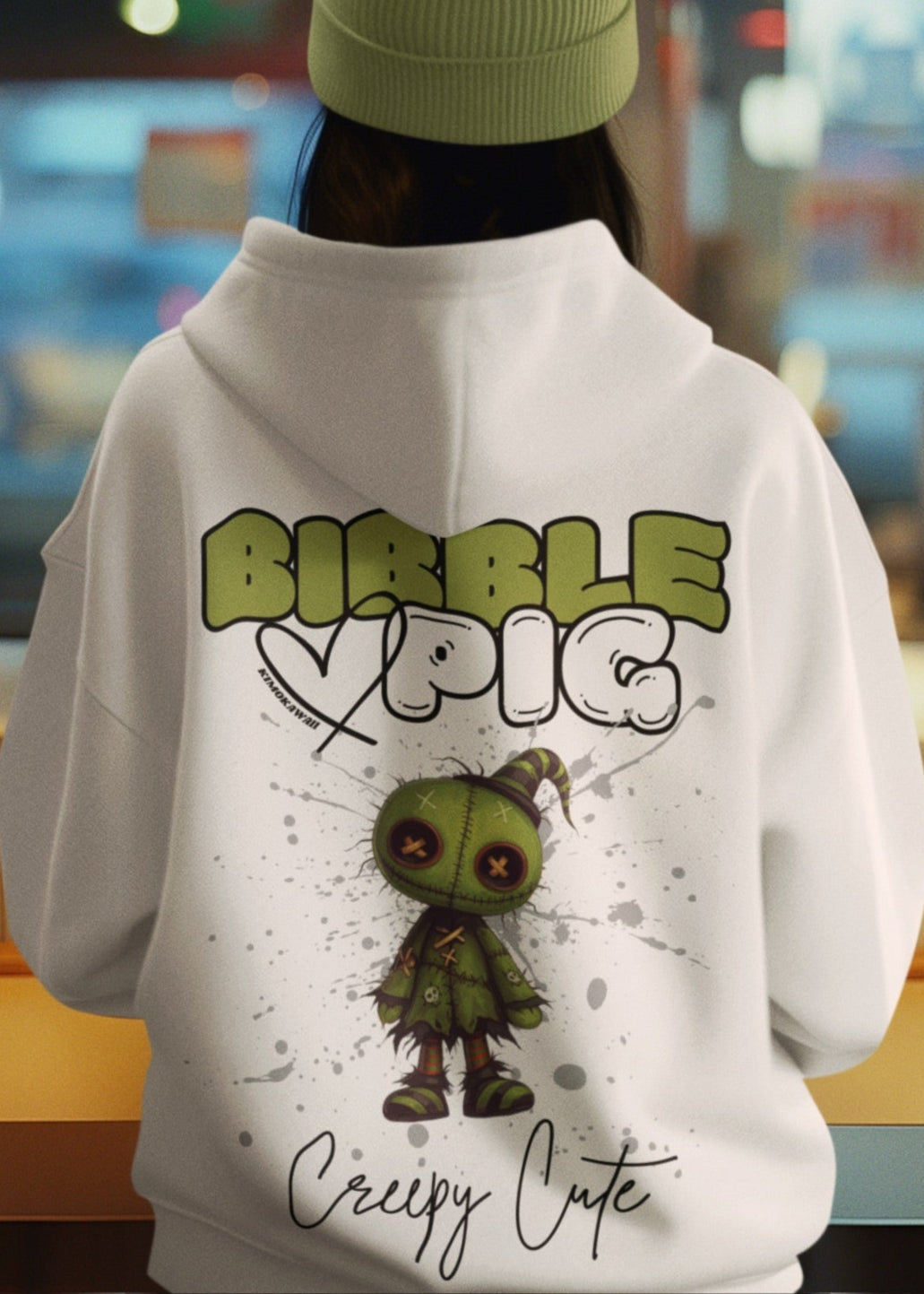 Close up of a model wearing eco-heather organic hoodie featuring goth style creepy cute Tattered Stitches graphic.   