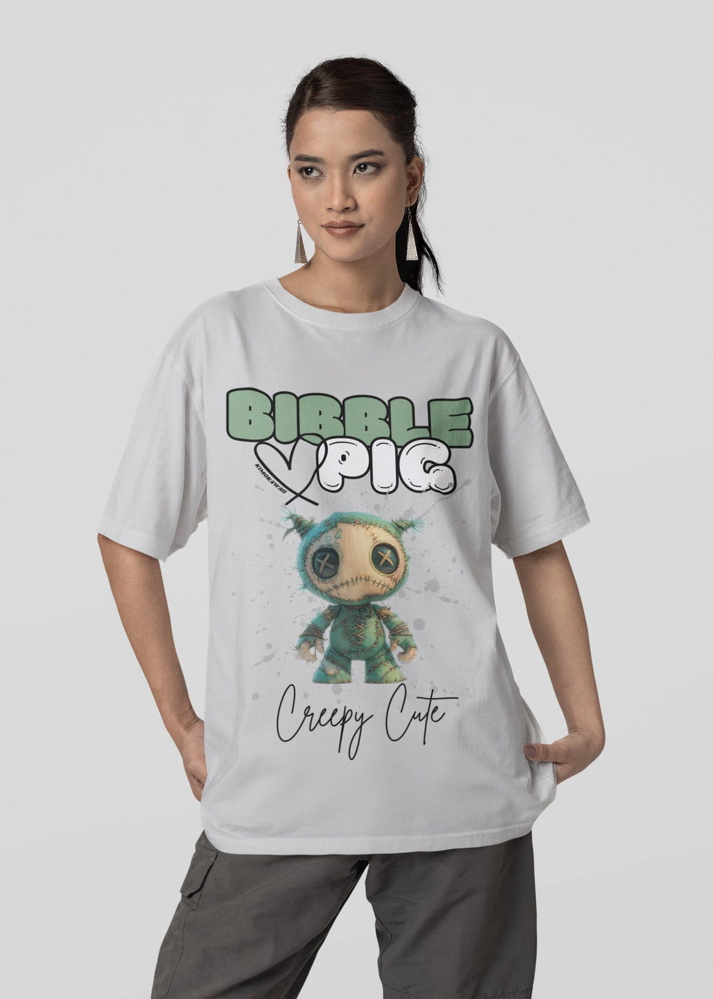 Model wearing grey oversized t-shirt featuring Night Terror Voodoo doll graphic and bold Bibble Pig Logo.