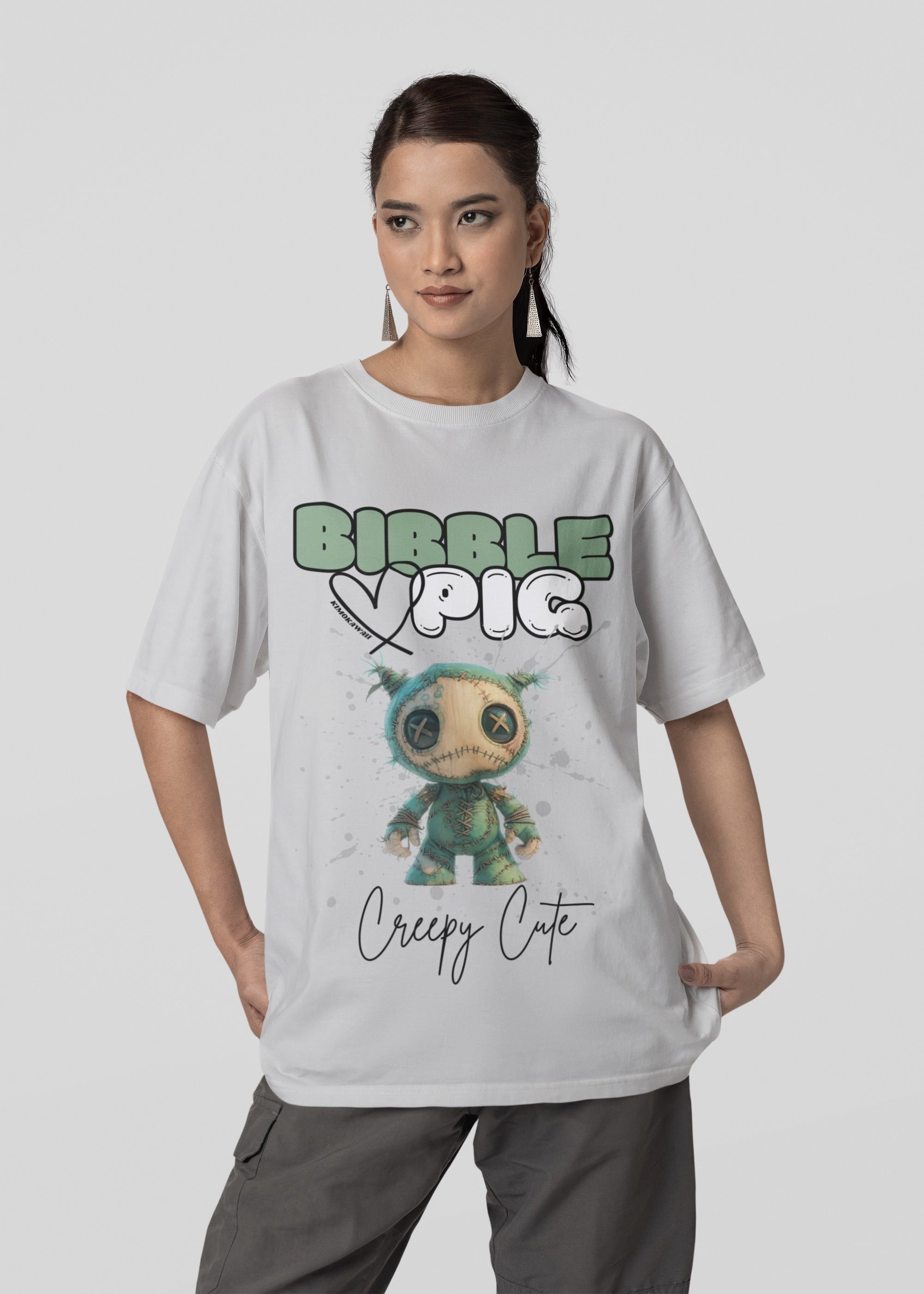 Model wearing grey oversized t-shirt featuring Night Terror Voodoo doll graphic and bold Bibble Pig Logo.