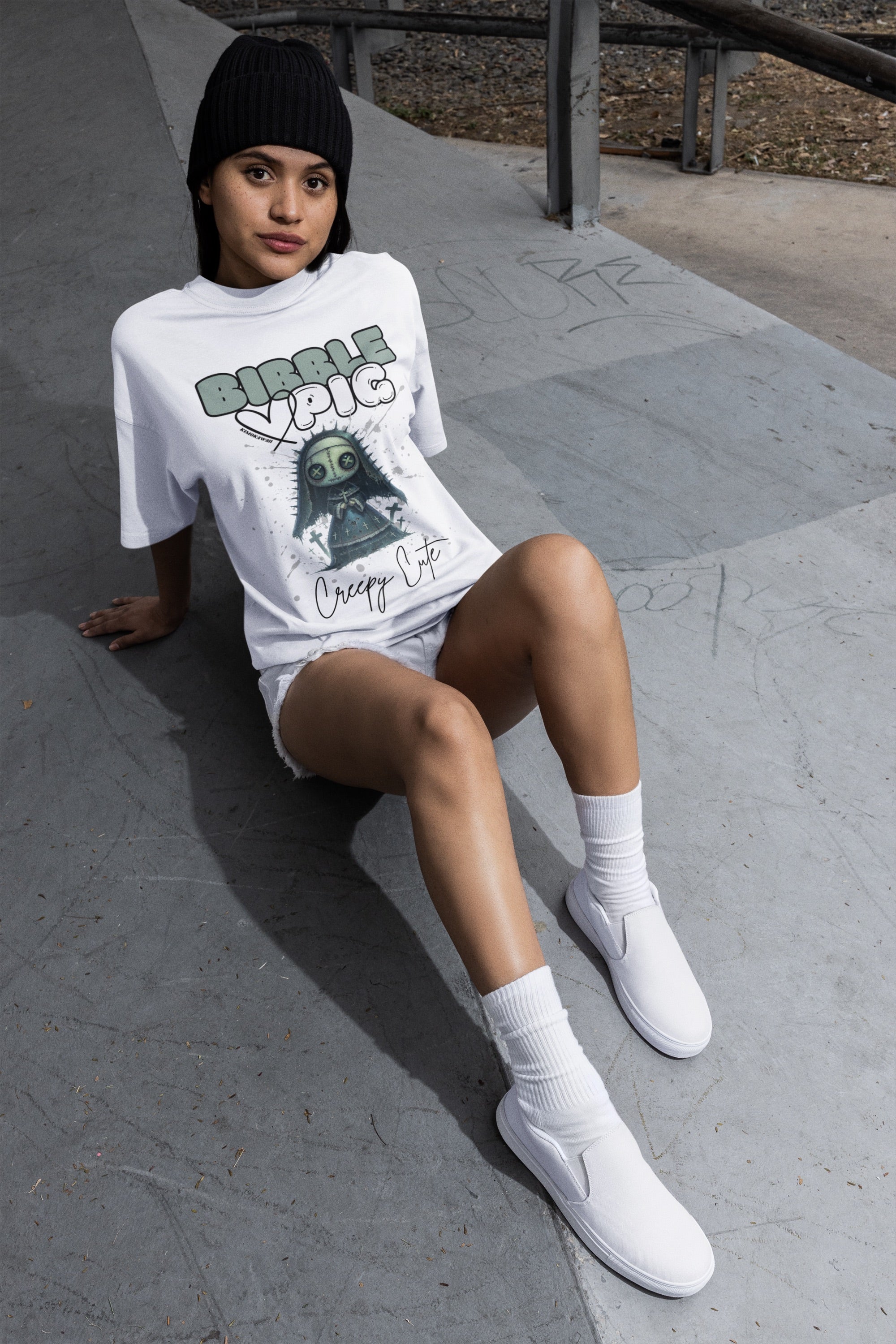 Model wearing white oversized t-shirt featuring Nightshade Nun Voodoo doll graphic and bold Bibble Pig Logo.   