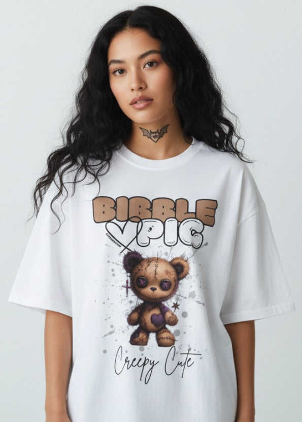 Model wearing an oversized organic t-shirt with gothic style voodoo teddy bear and large bibble pig logo.  Kimokawaii streetwear.