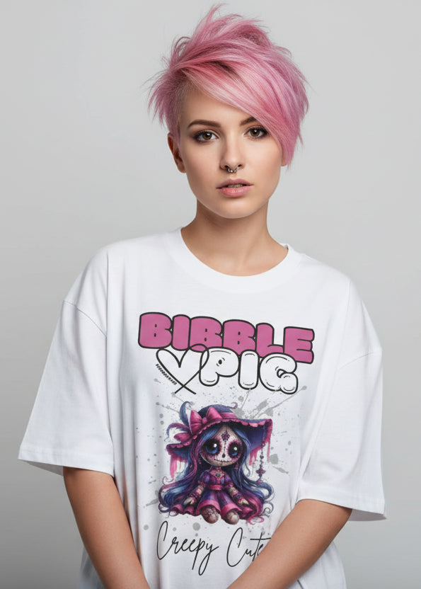Woman wearing a white oversized organic t-shirt with creepy cute voodoo doll graphic and large bibble pig logo.
