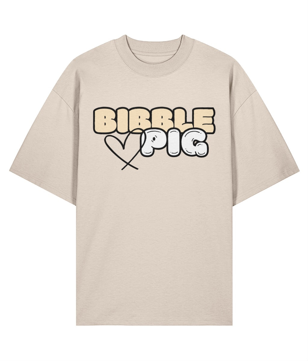 Flat lay view our a cream oversized organic t-shirt with our Vanilla Bibble Pig Bold Logo and cute heart design.