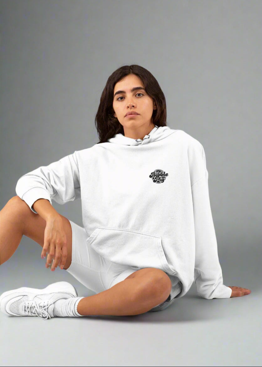 Model wearing a white oversized organic hoodie with large Bubblegum Bold Logo and cute heart design front view.