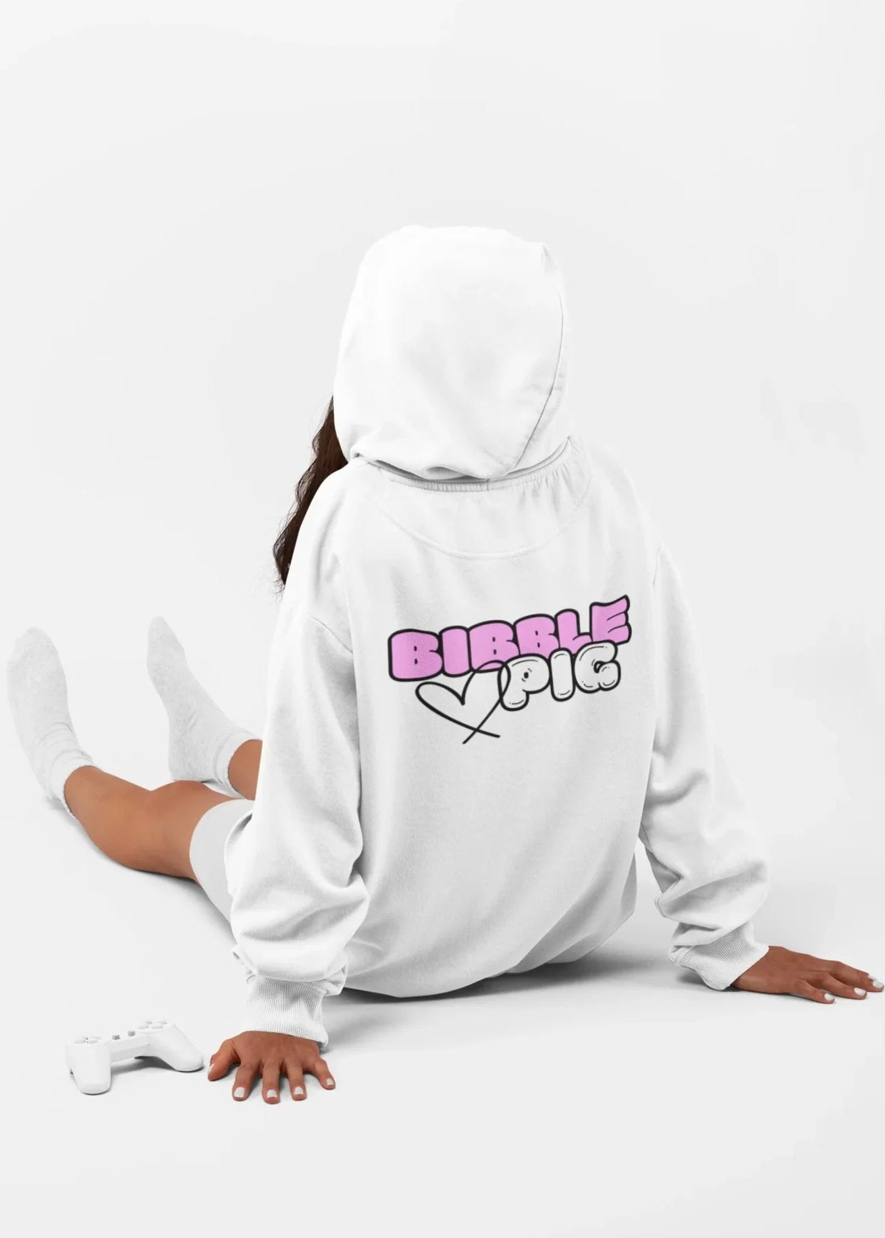 Model wearing a white oversized organic hoodie with large Bubblegum Bold Logo and cute heart design.