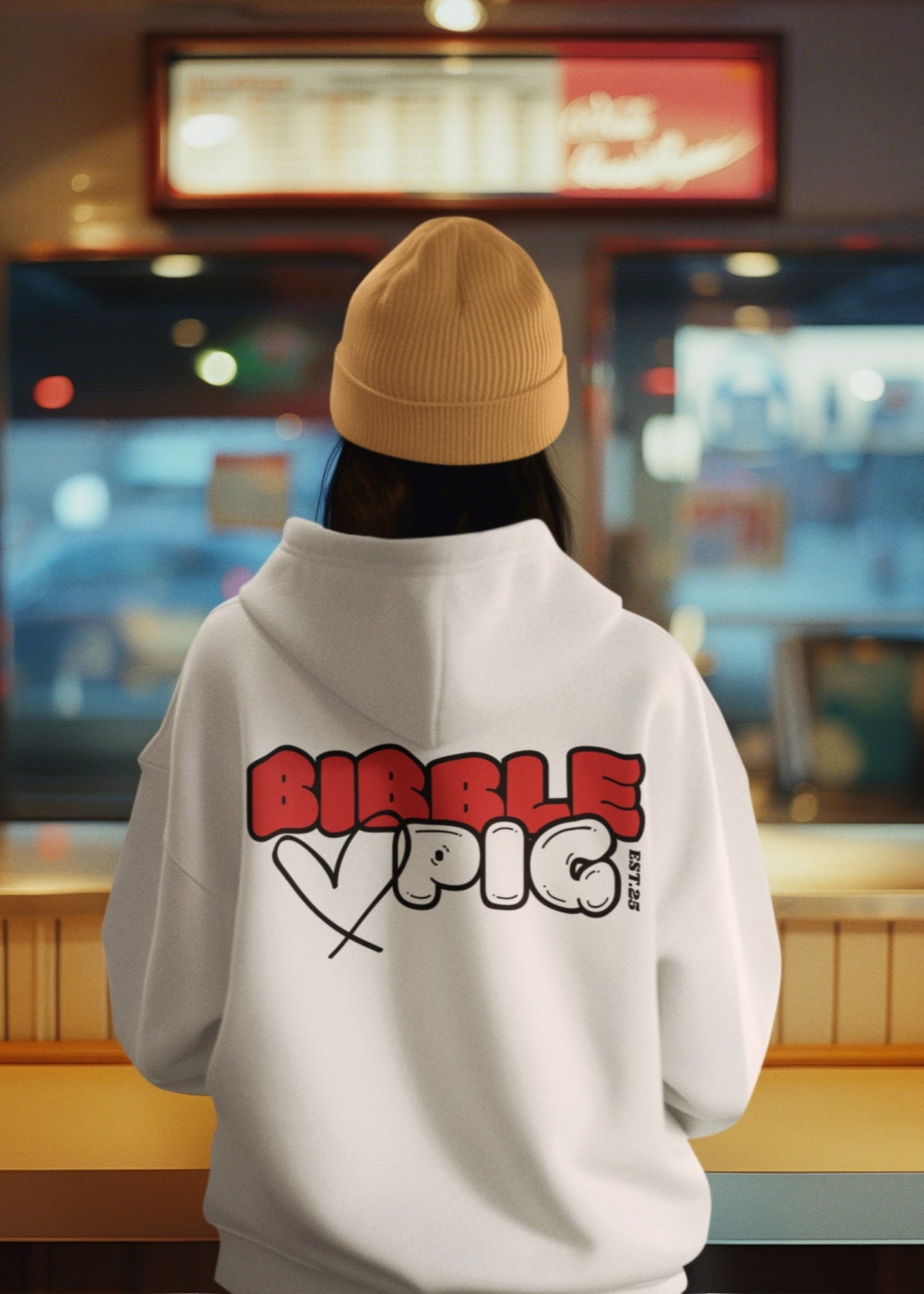 Model wearing a white oversized organic hoodie with our Red and White Bold Logo and cute heart design. 
