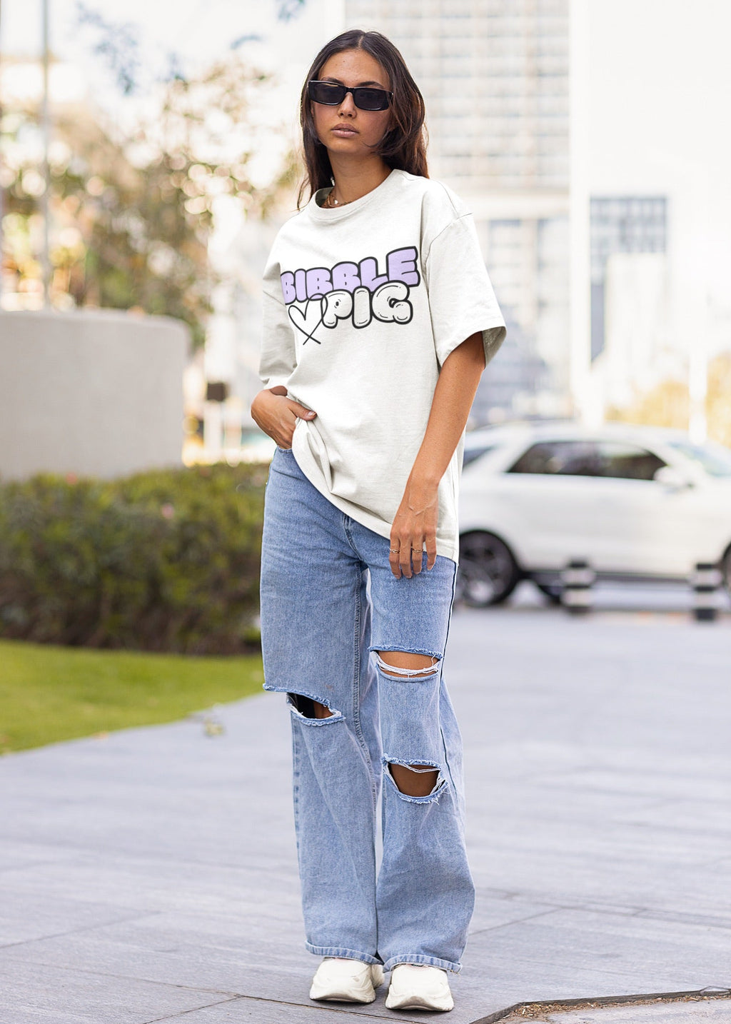 Model wearing a white oversized organic t-shirt with large Lavender Bold Logo and cute heart design.