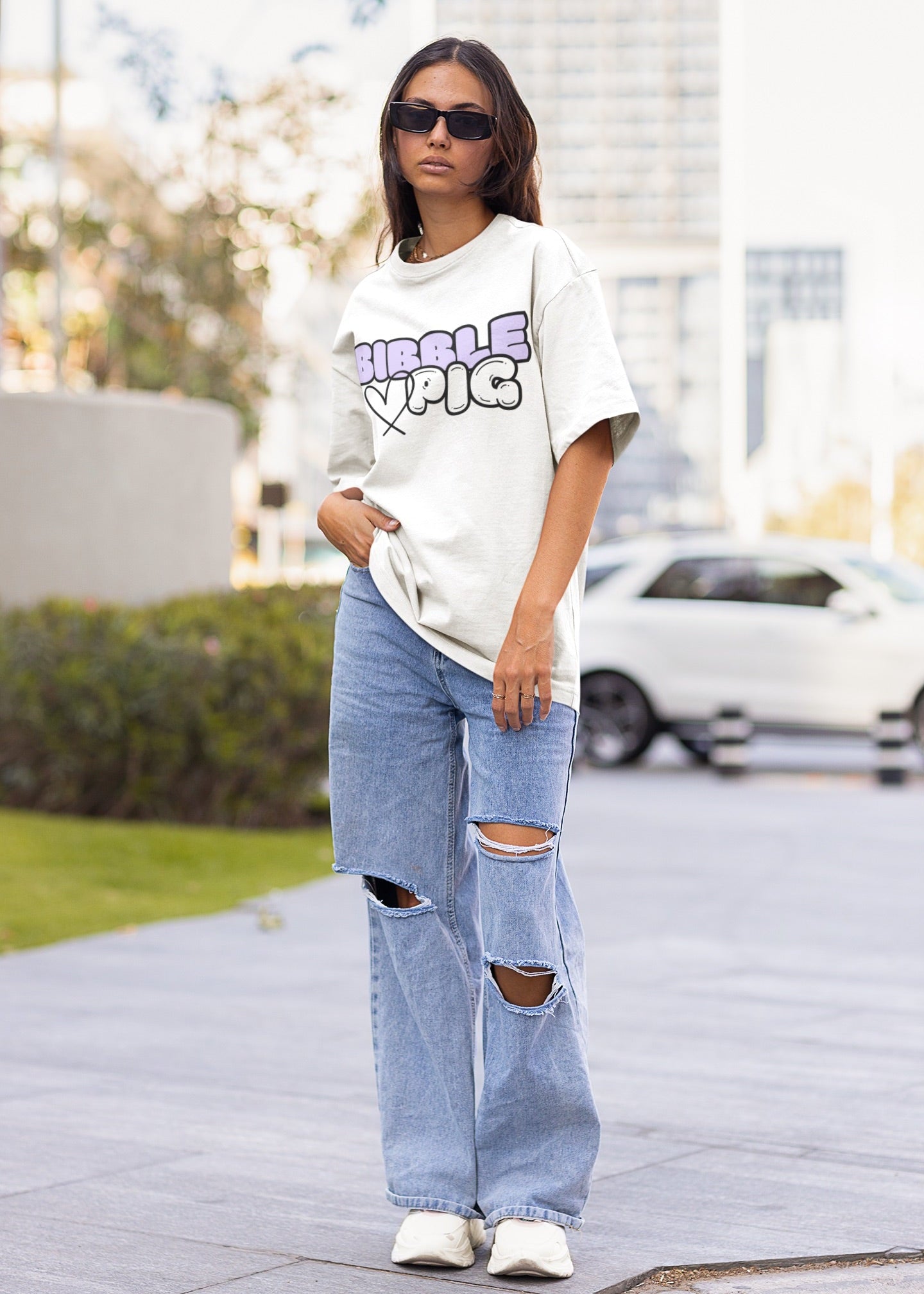 Model wearing a white oversized organic t-shirt with large Lavender Bold Logo and cute heart design.
